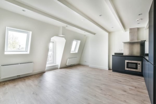Black kitchen in a minimalist style. parquet floor and white walls